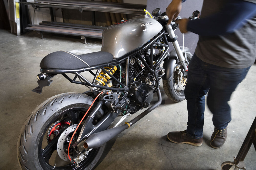 Oscar showing a custom Ducati he is building