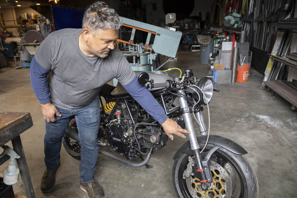 Oscar showing a custom Ducati he is building