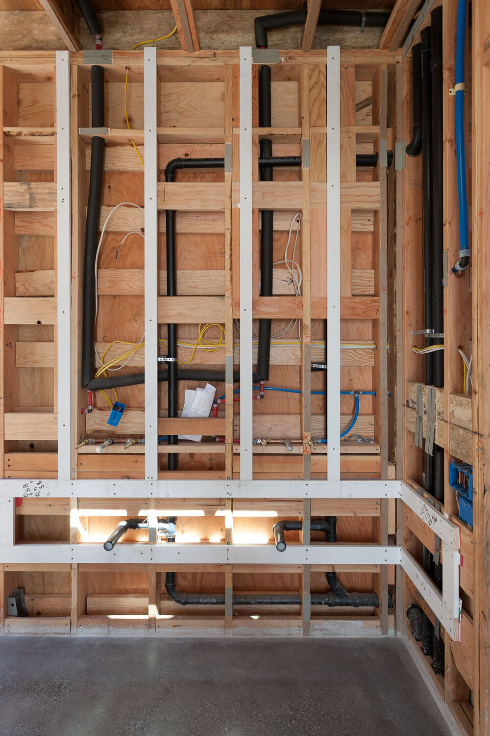 Plumbing fixtures before and after installation of drywall.