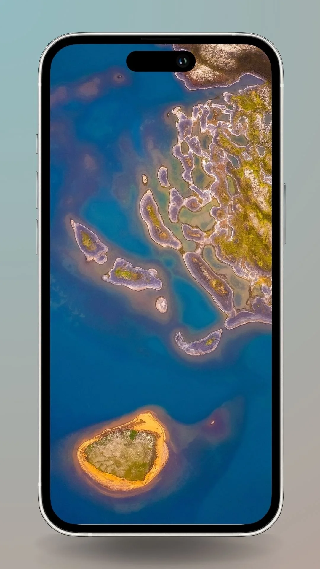 Aerial view of abstract Icelandic terrain with vibrant blue water and intricate land formations. Downloadable as a smartphone wallpaper.