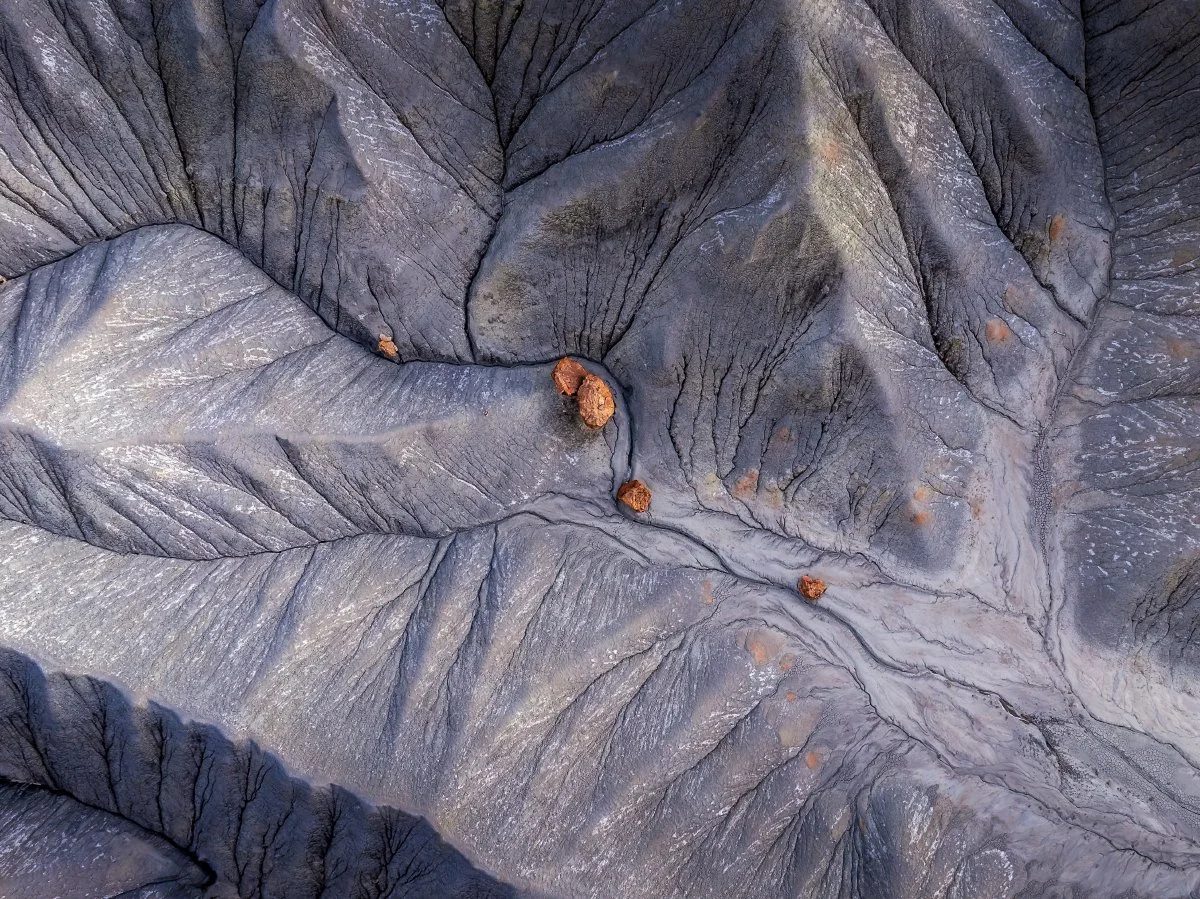 Aerial view of textured Utah desert landscape with intricate patterns and scattered rock formations, captured with a DJI Mavic 3 Pro in 2024