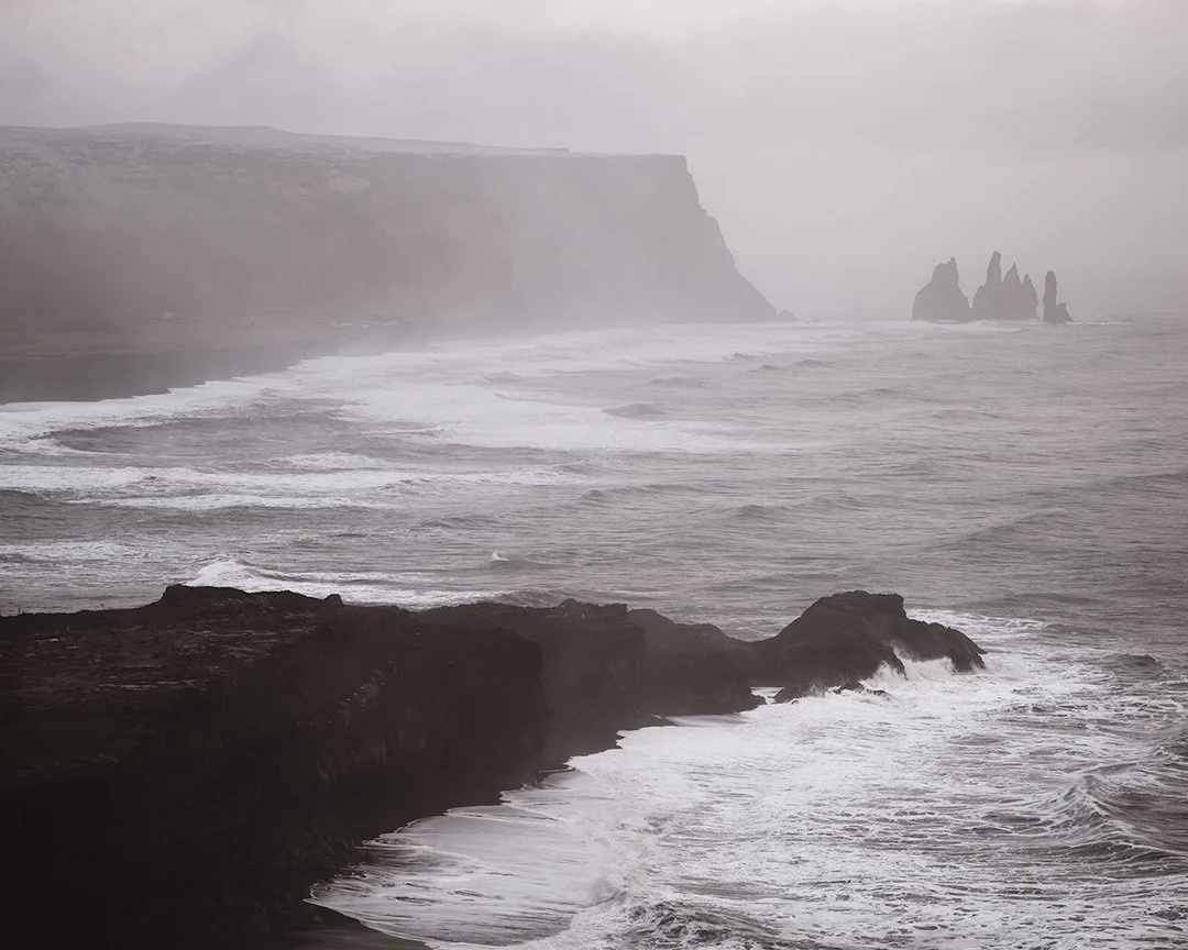 Reynisfjara, Iceland with dramatic coastal landscape and iconic rock stacks in a moody seascape
  Coastal,Cold,Atmospheric  