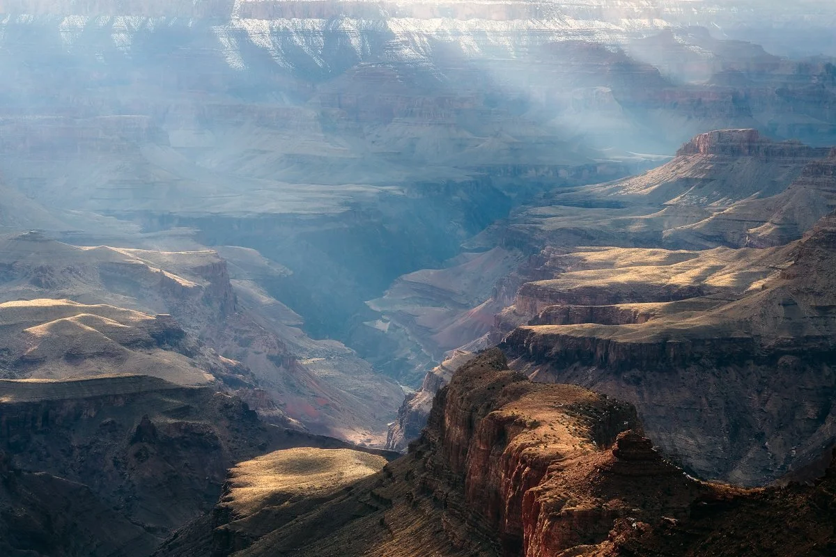 Grand Canyon: Majestic Landscape, Sunlit Cliffs, Expansive Views, Natural Wonder.
  Atmospheric, Light, Intimate Landscapes, Cold  