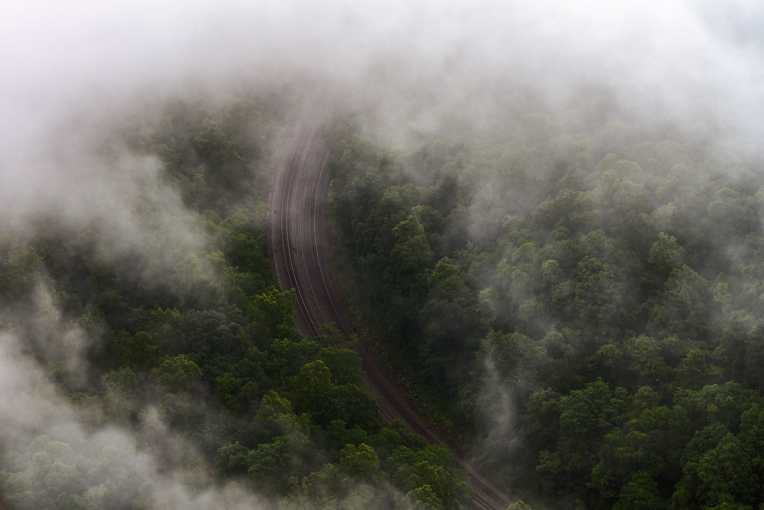 New River Gorge photo: misty forest, winding railroad, serene landscape.
  Atmospheric, Intimate Landscapes, Light  