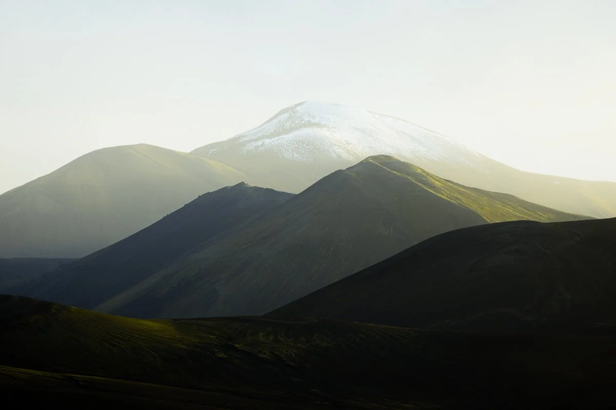 Scenic mountains in the Highlands of Iceland with snow-capped peaks and lush green valleys.
  Cold, Light, Intimate Landscapes, Golden Hour  