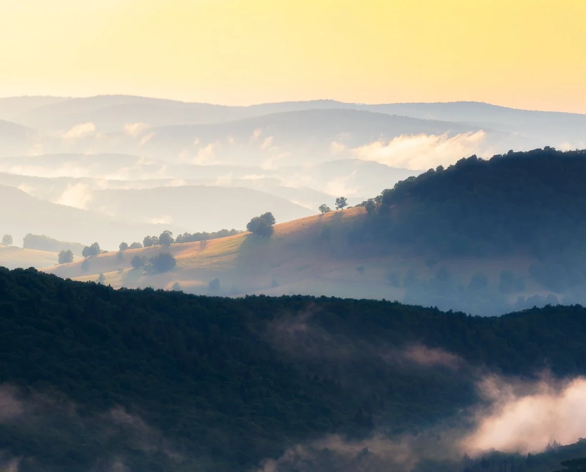 Sunset after a storm at Spruce Knob, West Virginia, with misty hills creating a serene atmosphere.
  Atmospheric, Golden Hour, Light  