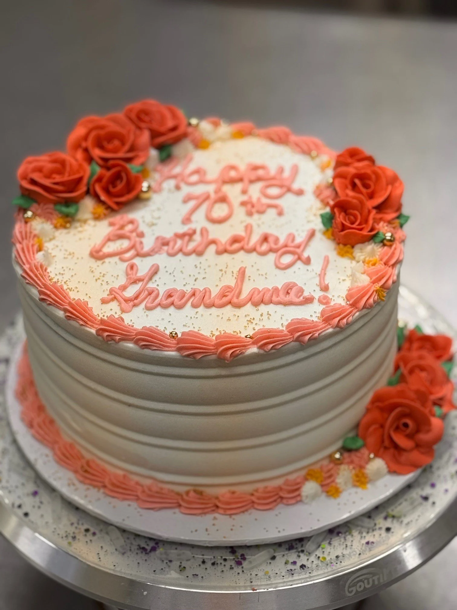 70th birthday orange flower themed cake