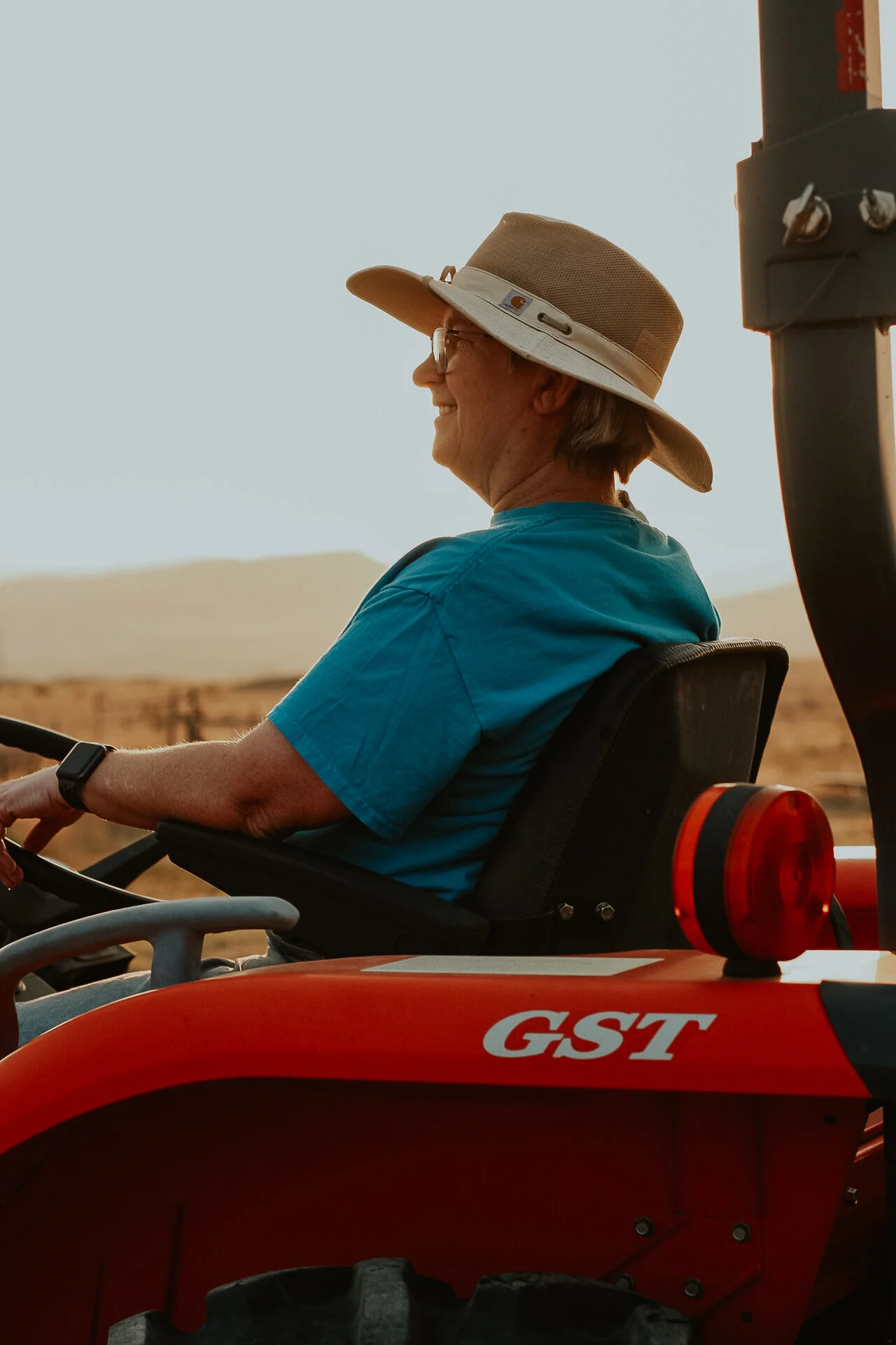My mom loves to drive her tractor around the farm. I took this photo during golden hour, and I love how the backlight frames her and the tractor. Golden hour is my favorite time to take photos because it makes everything look almost "heavenly." 