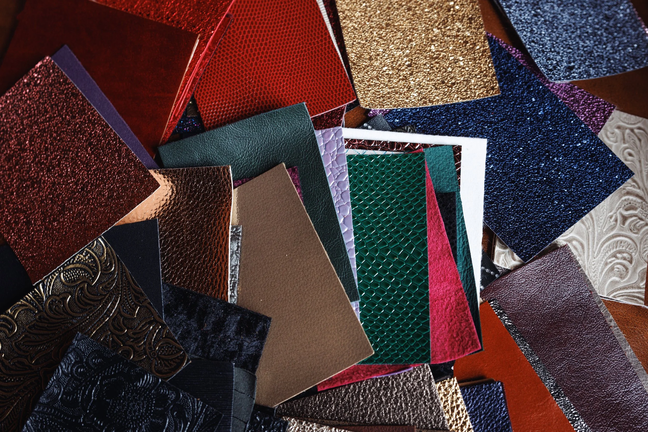 A collection of boudoir album cover swatches featuring different textures and colors for custom album design.