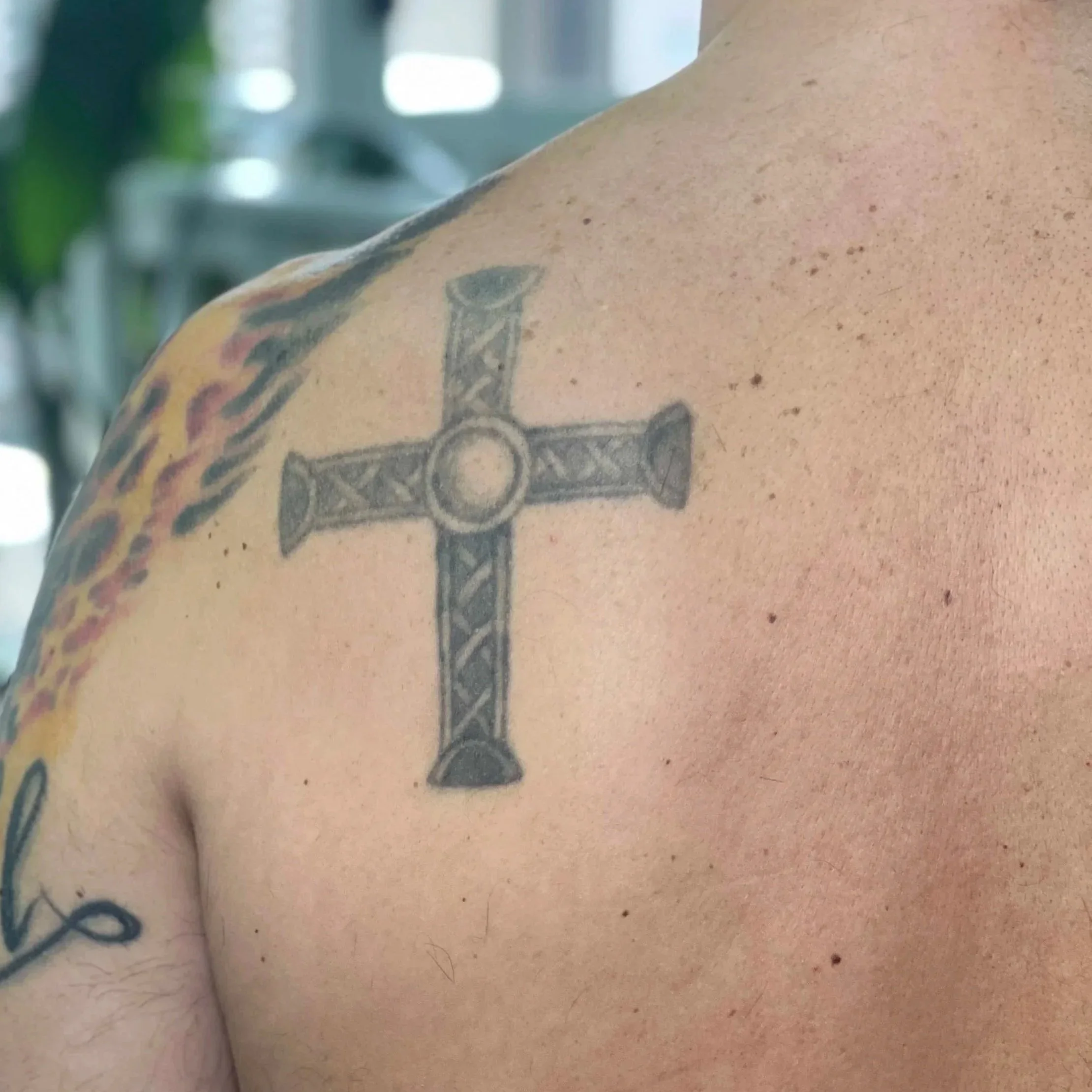 Before: Old cross tattoo on back of shoulder, pre-cover-up
