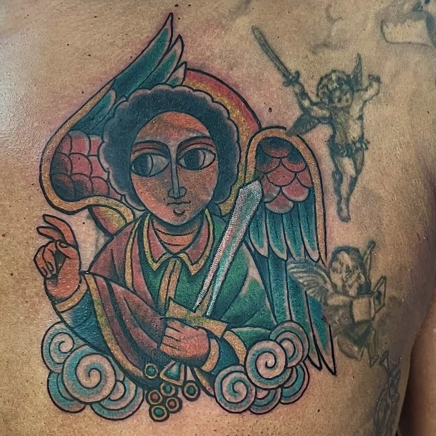 After: Ethiopian angel cover-up tattoo in color on brown skin, Sandy Springs