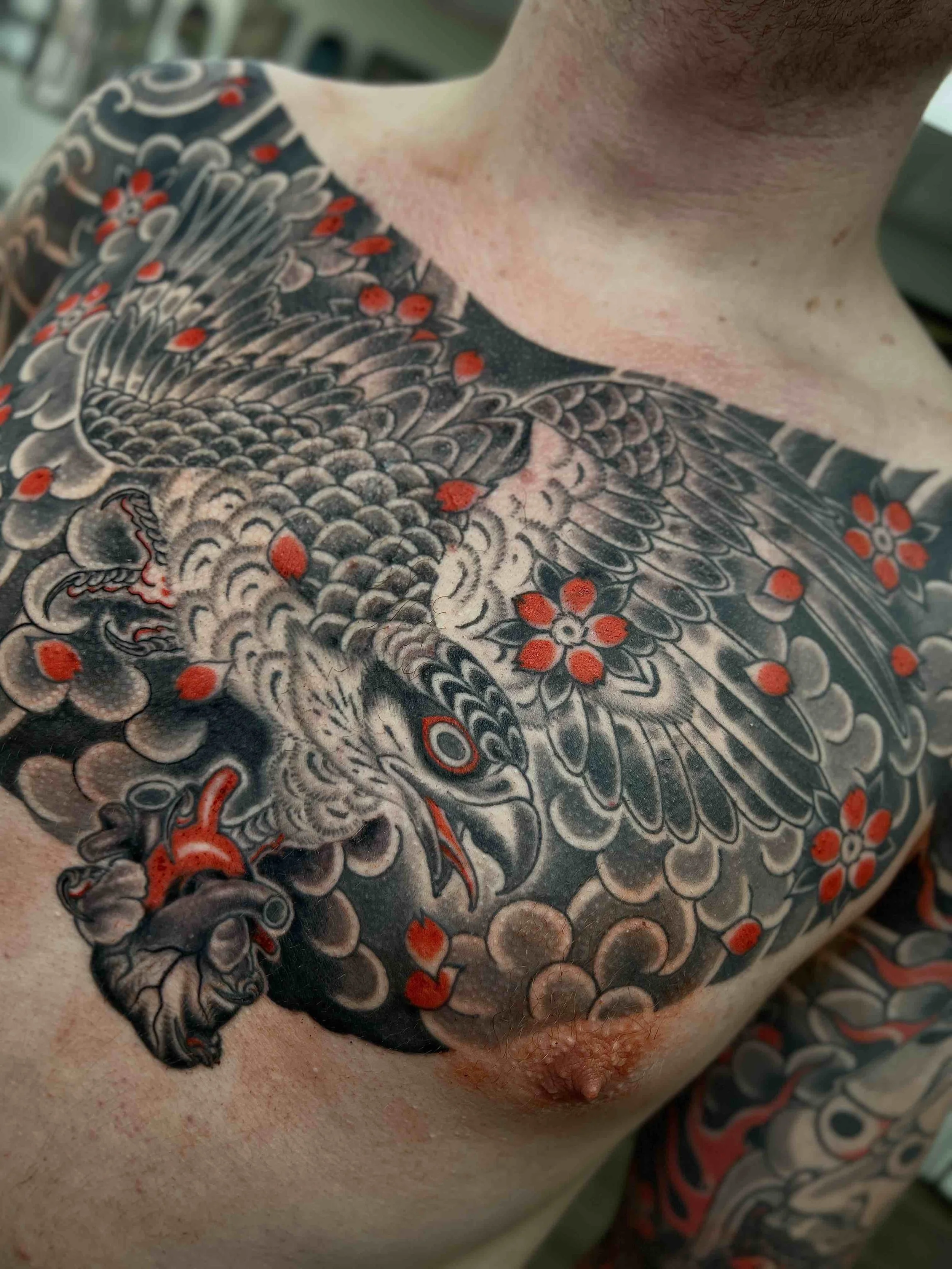 Japanese hawk and cherry blossom chest tattoo by Wes Holland in Atlanta, GA