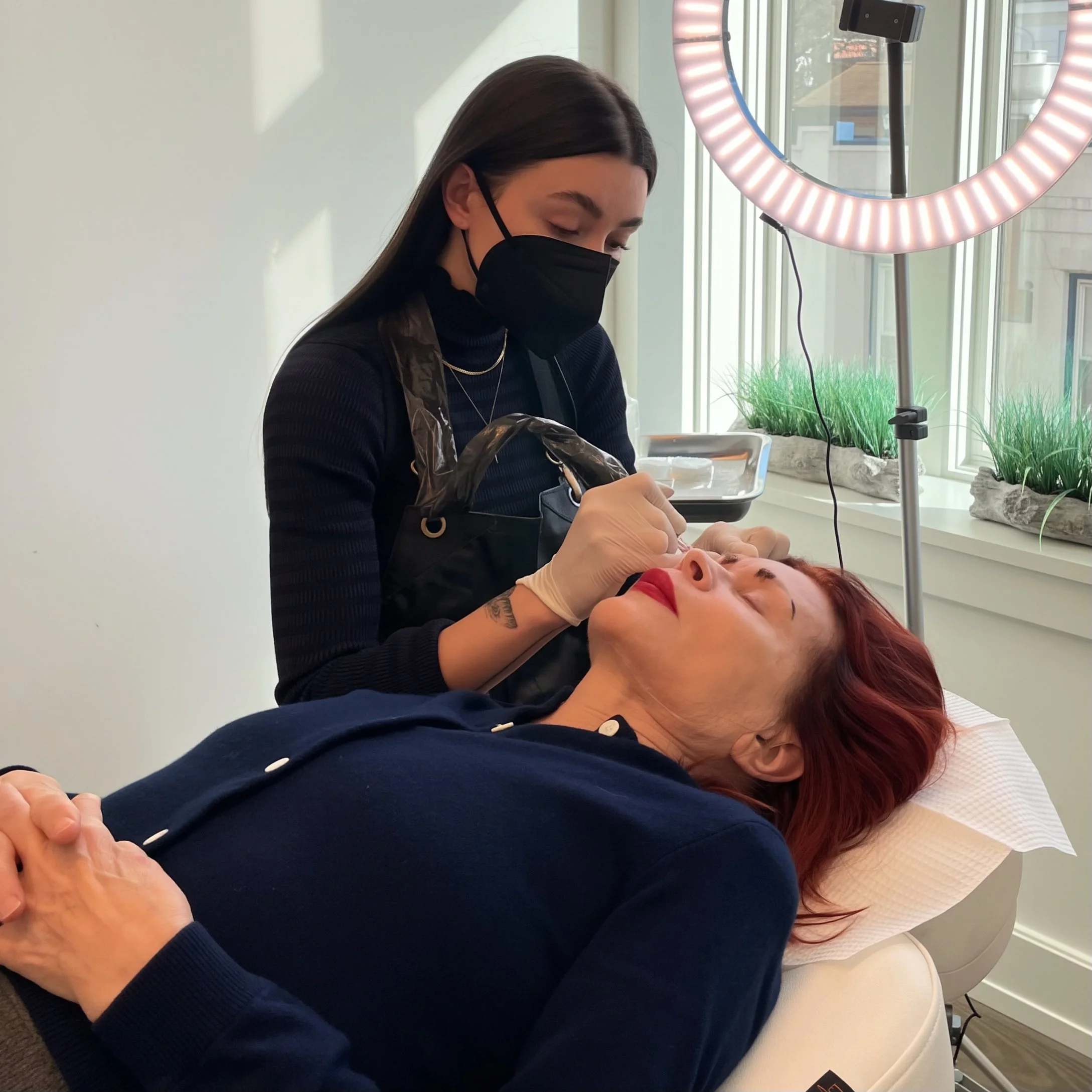 Marina Zakhrabova performing a cosmetic tattoo treatment on a client in New York City