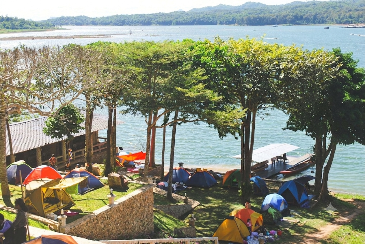 Colorful camping tents pitched on a grassy lawn next to a lake surrounded by trees and mountains at P. Guest House and Country Resort.
