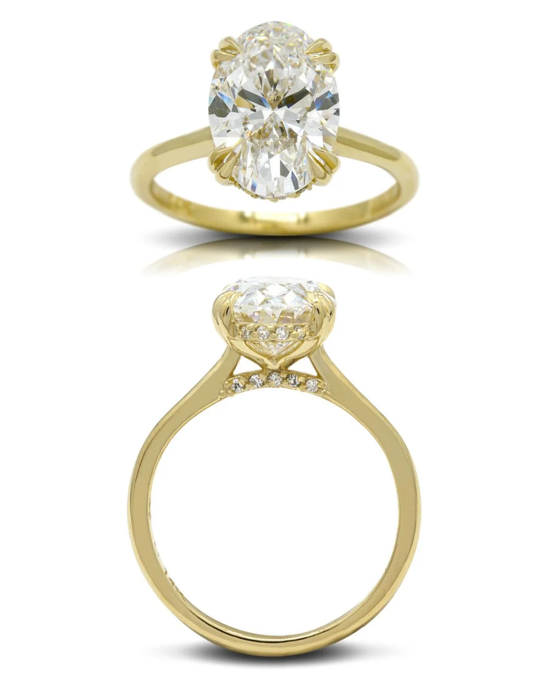 A magnificent 3.77-carat oval-cut diamond stands as the centrepiece on this custom engagement ring, held securely by distinctive pointed double claws. A hidden halo further enhances the delicate, thin yellow gold band, creating a secret layer of spar