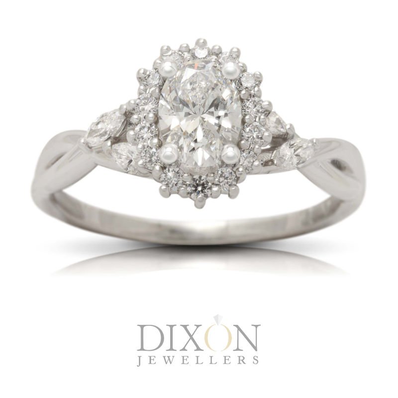 This custom engagement ring features a glittering oval center stone nestled in a snowflake-style cluster halo, all set atop a marquise-accented, gracefully twisted band.
