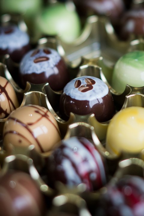 A collection of decorated chocolate Easter eggs in various colors and designs.