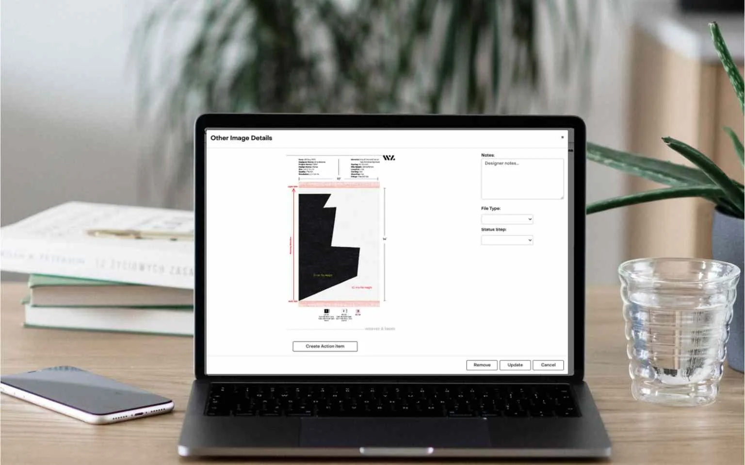 Laptop on a desk with rug design software on screen, indicating remote design capabilities.