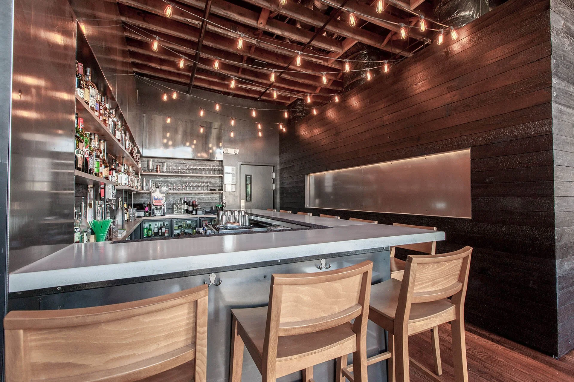 Industrial modern bar with steel, concrete and black at a restaurant in RiNo.