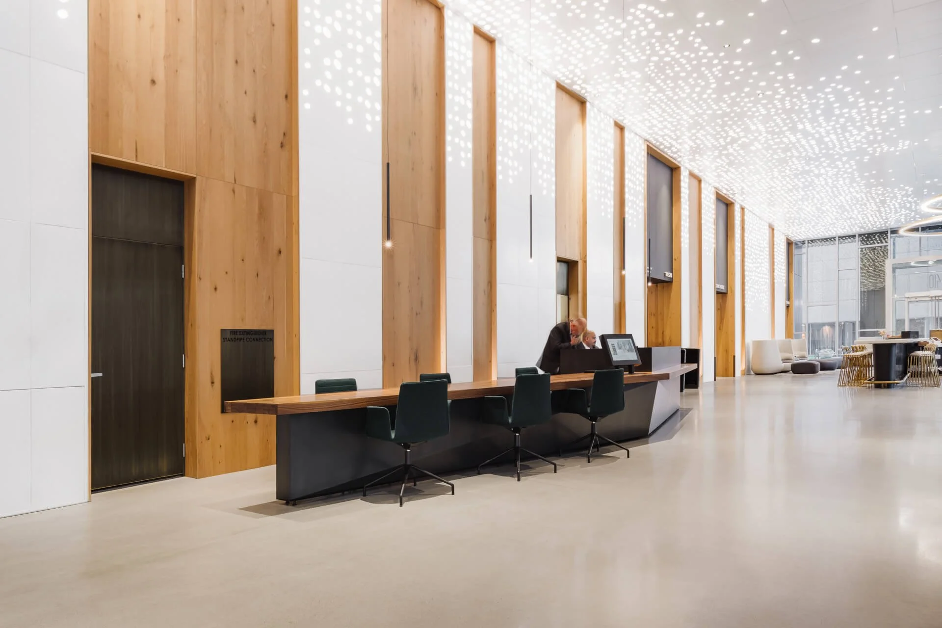 faceted Steel and walnut entry desk at the 410 building in downtown denver