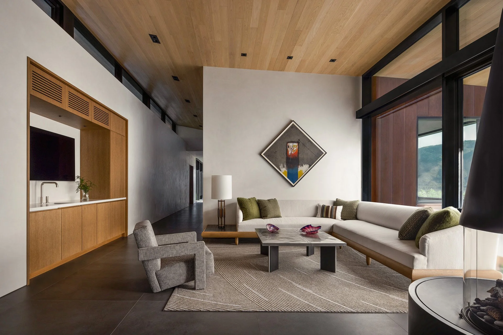 modern home interior with a circular concrete fireplace