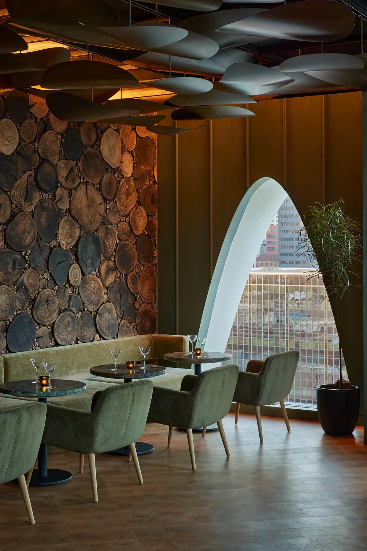 Metal ceiling installation in a rooftop restaurant of a Denver Hotel with wood, green, and copper tones.