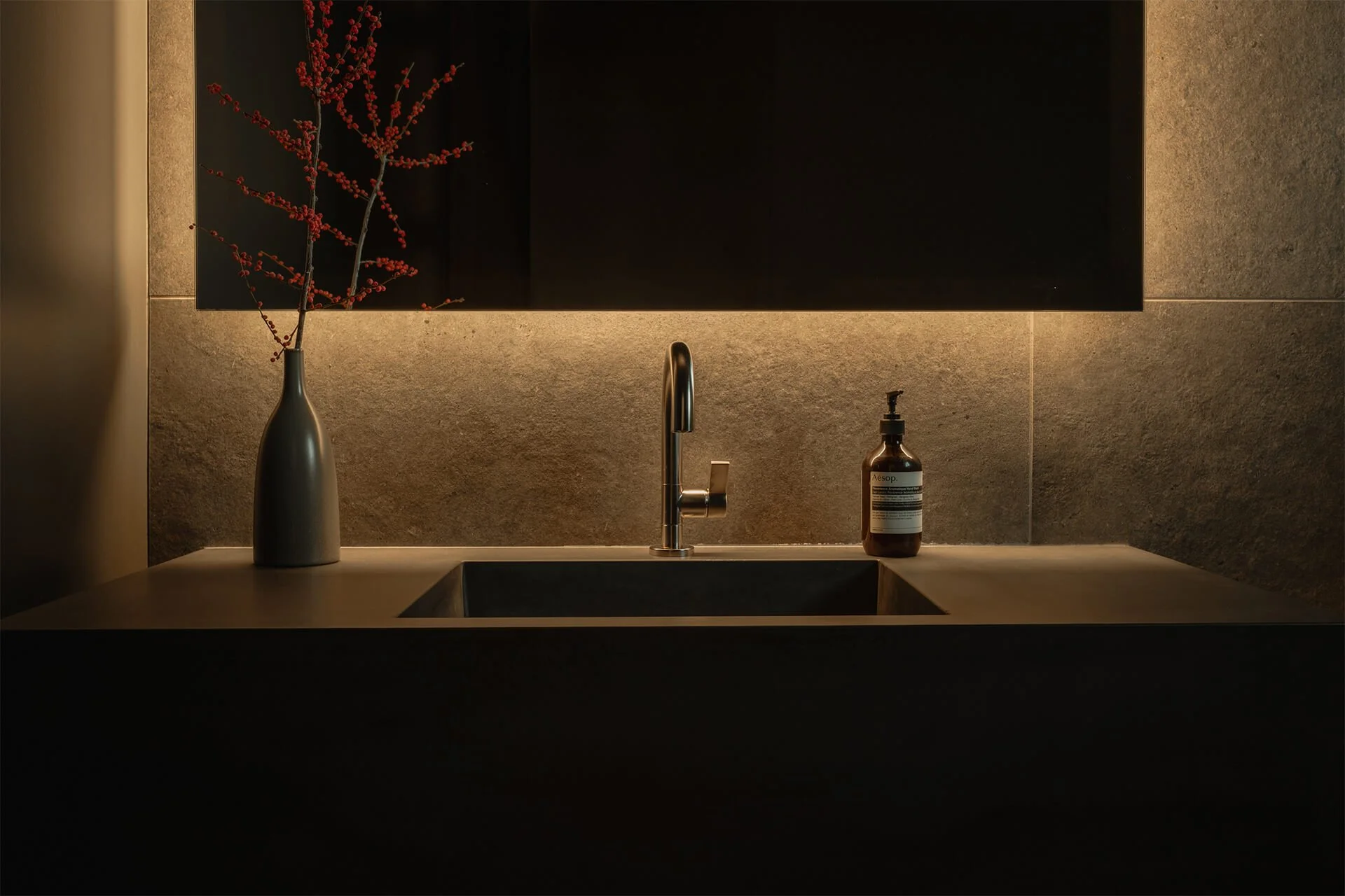 Modern black concrete vanity sink in moody bathroom