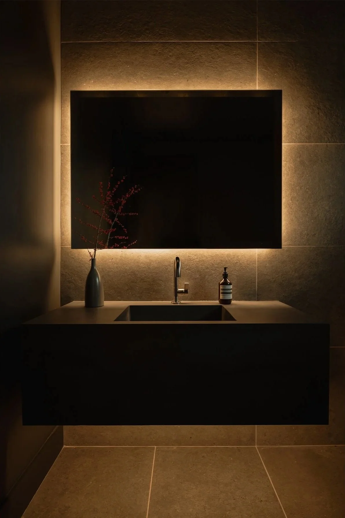 black concrete sink in moody bathroom