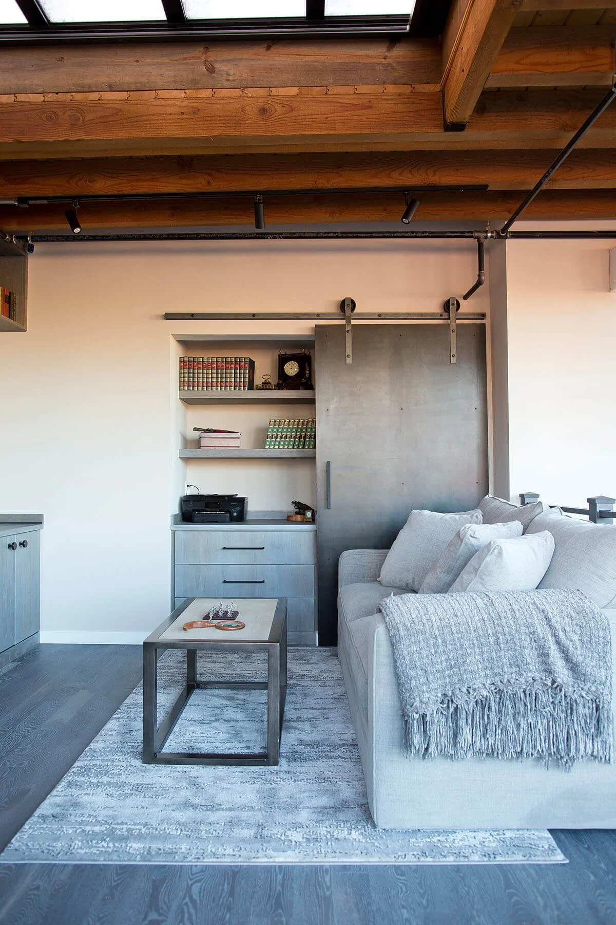 Modern industrial home office with rolling barn door.