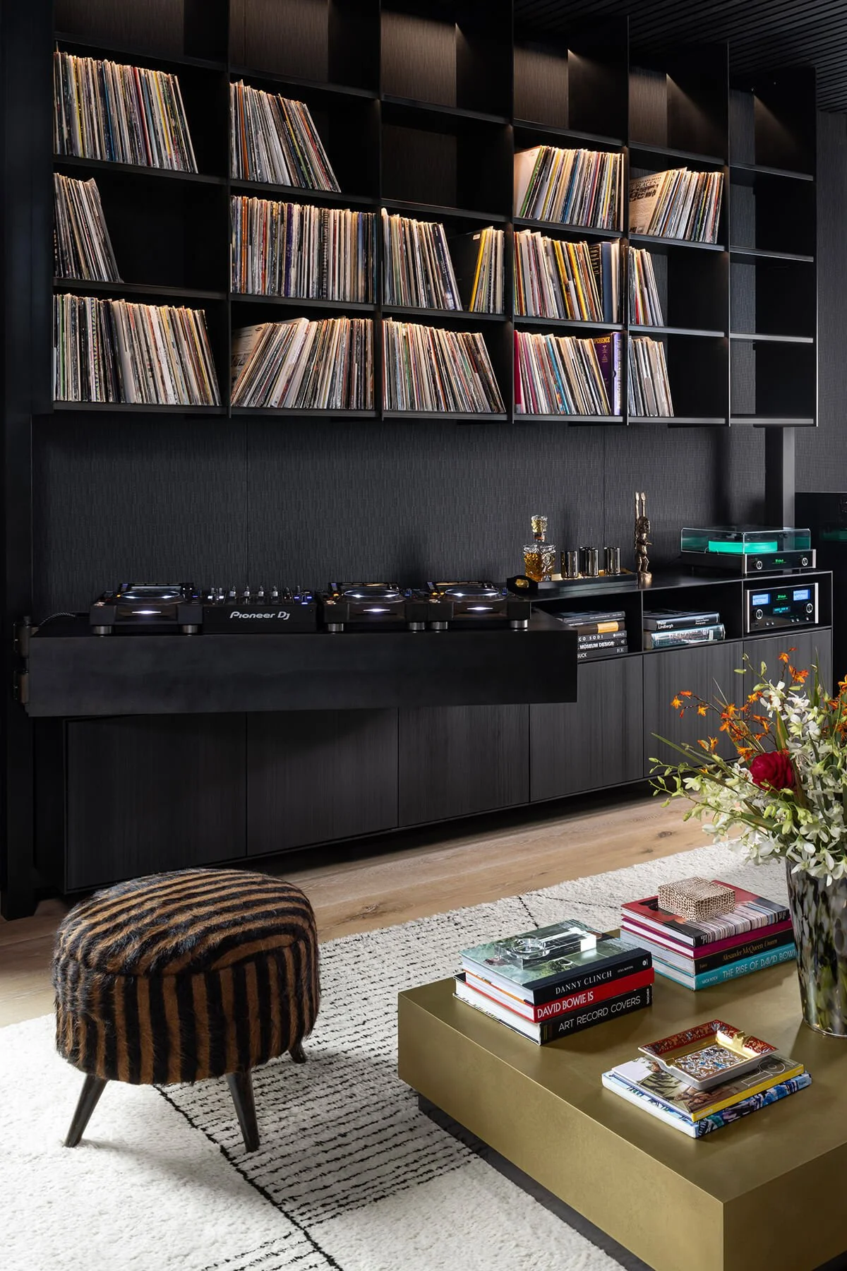 Custom fabricated blackened steel shelving and millwork wall for record storage and DJ setup, designed for a contemporary art collector’s residence in a converted historic building