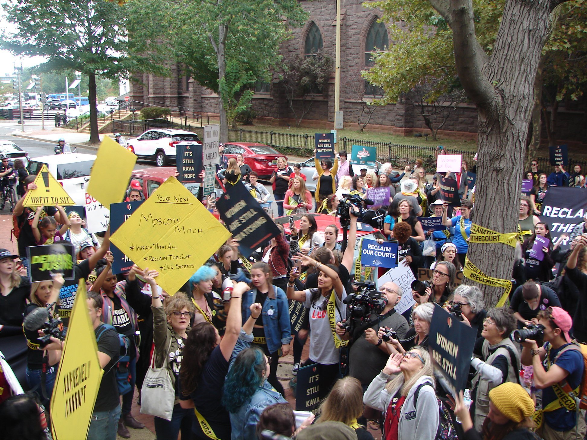 Protesters rally outside the house of the Senator McConnell.