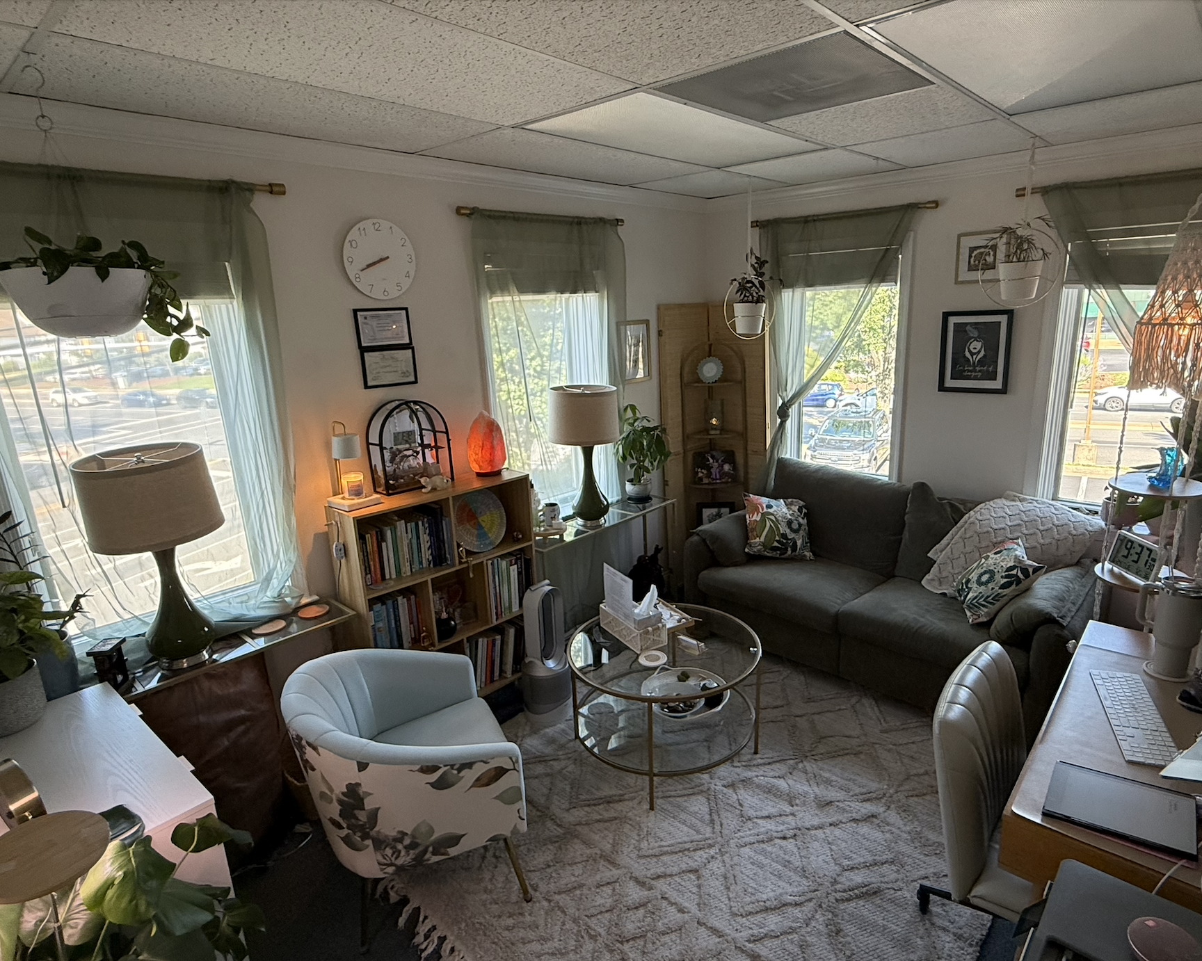 neutral office setting with green couch and blue chair and windows