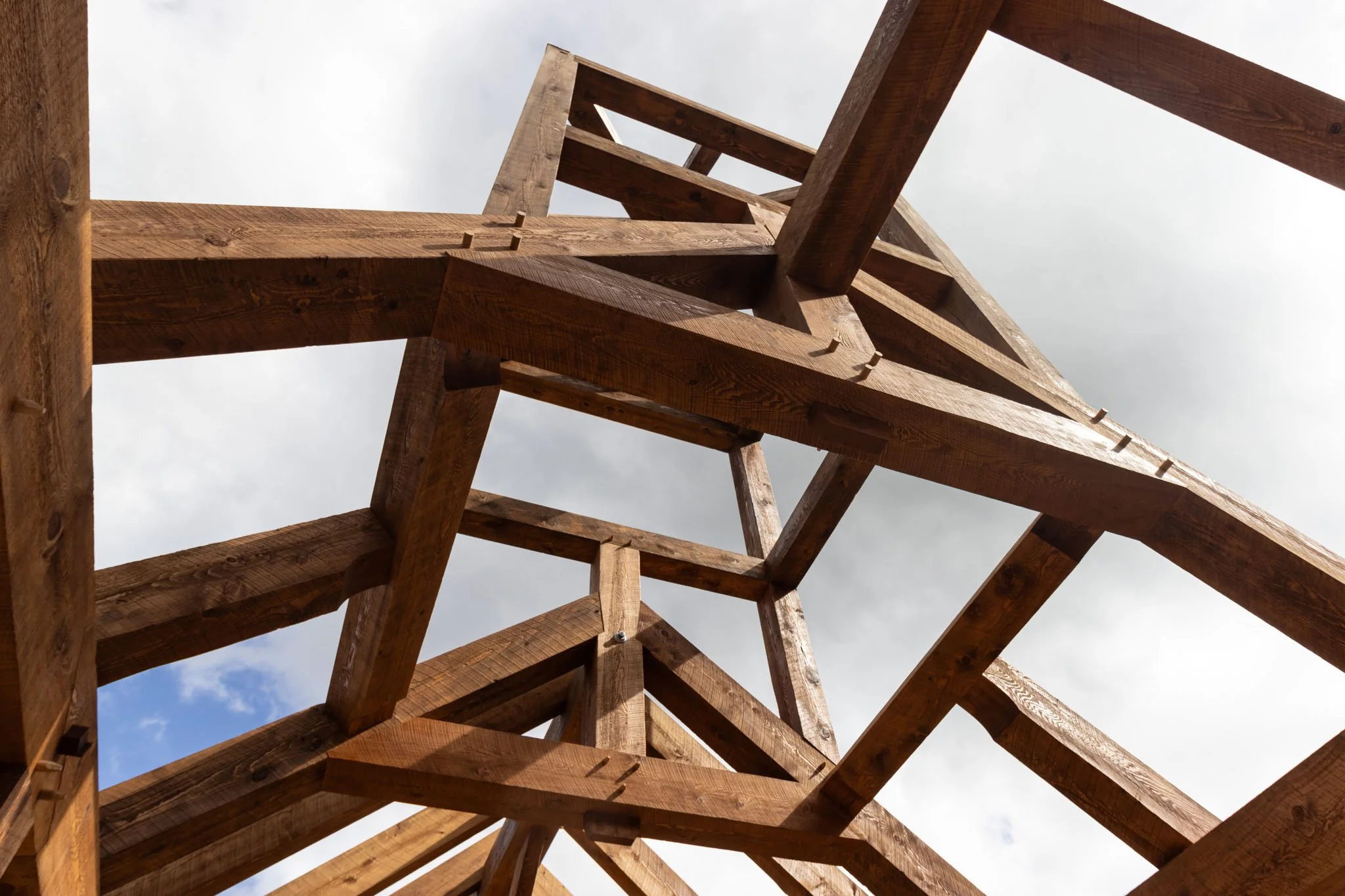 Wooden timber frame structure against cloudy sky