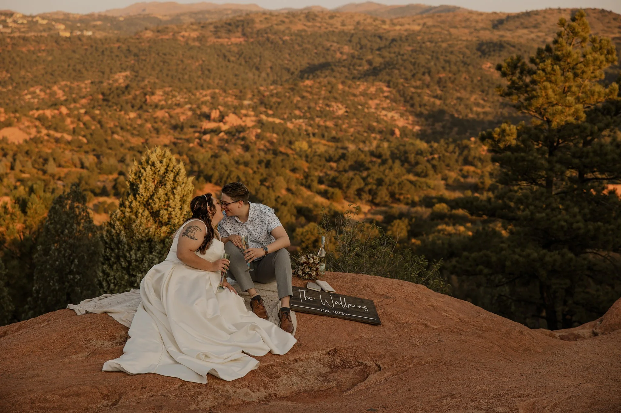 Couple kissing on red rock overlook during a Garden of the Gods elopement in Colorado Springs at sunrise.
