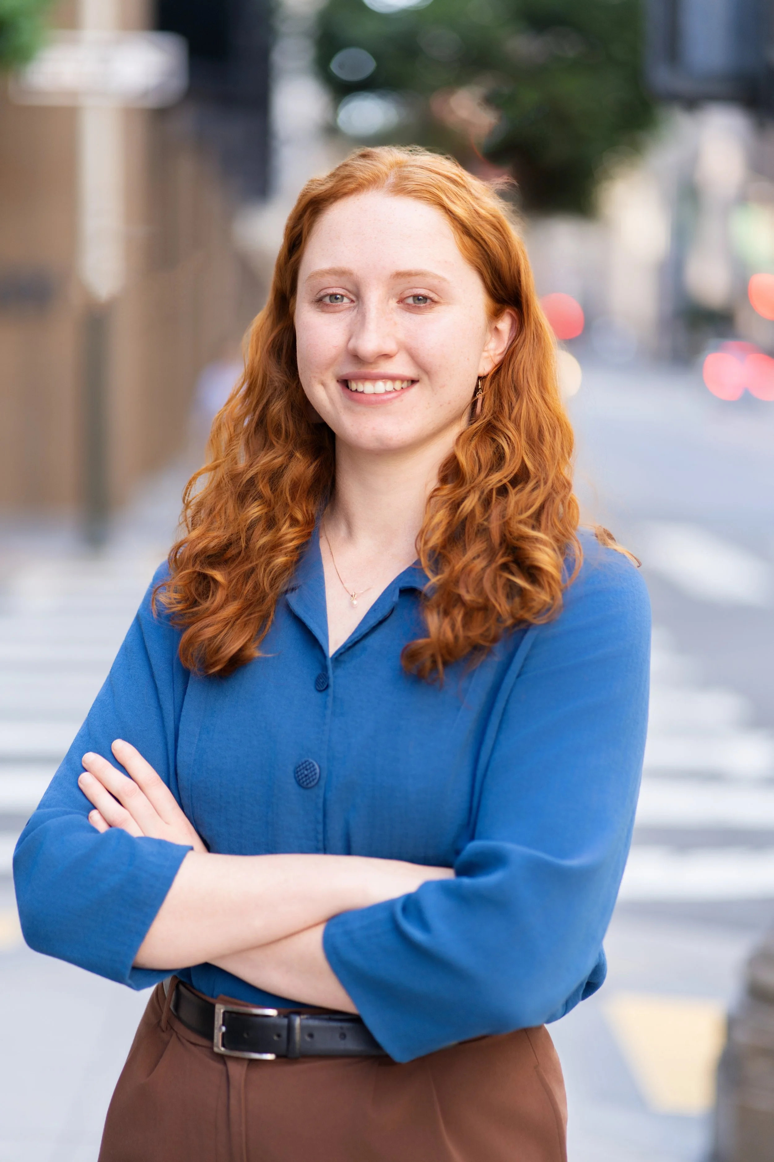 A professional headshot of a woman with her arms crossed in the finance industry. Taken in the Financial District of San Francisco.