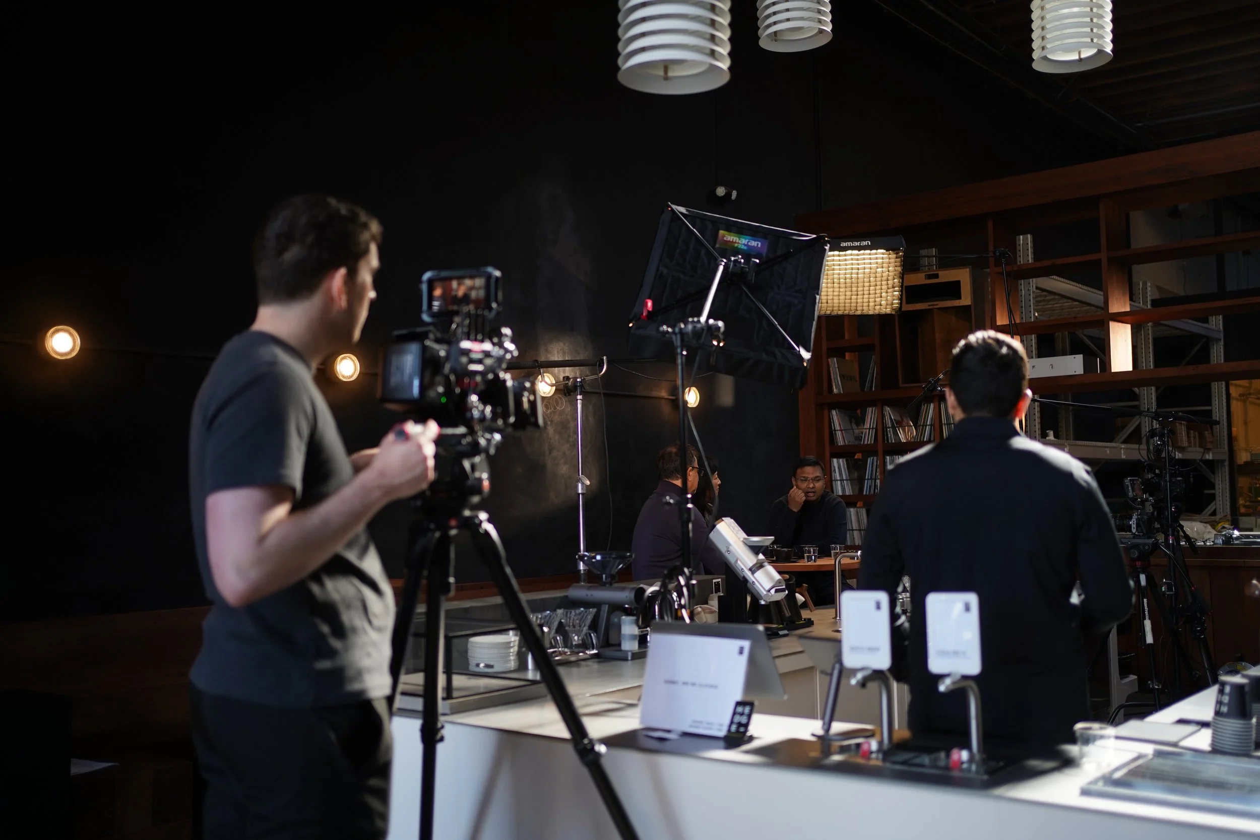Videographer from 415Headshots Inc. capturing an interview at a cafe