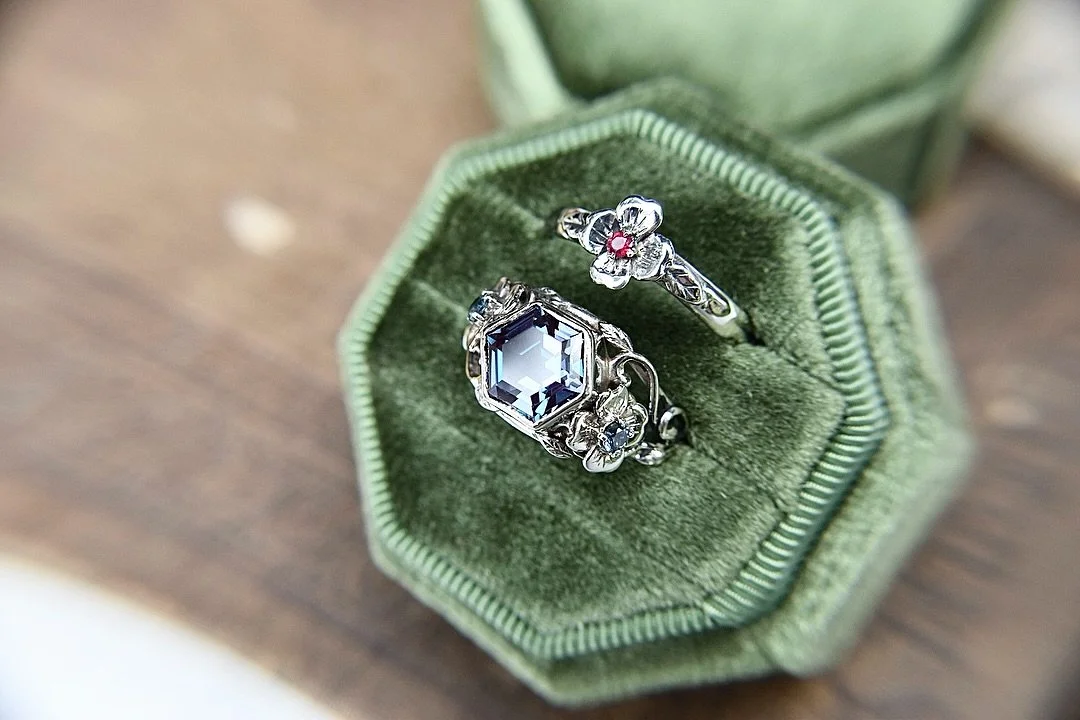 A custom wedding set I just finished. Made in 14k white gold with a large alexandrite center and teal sapphire and ruby accents. The flowers on the sides are Dogwood 🥰. If you&rsquo;re interested in custom versions of my designs you can reach out on