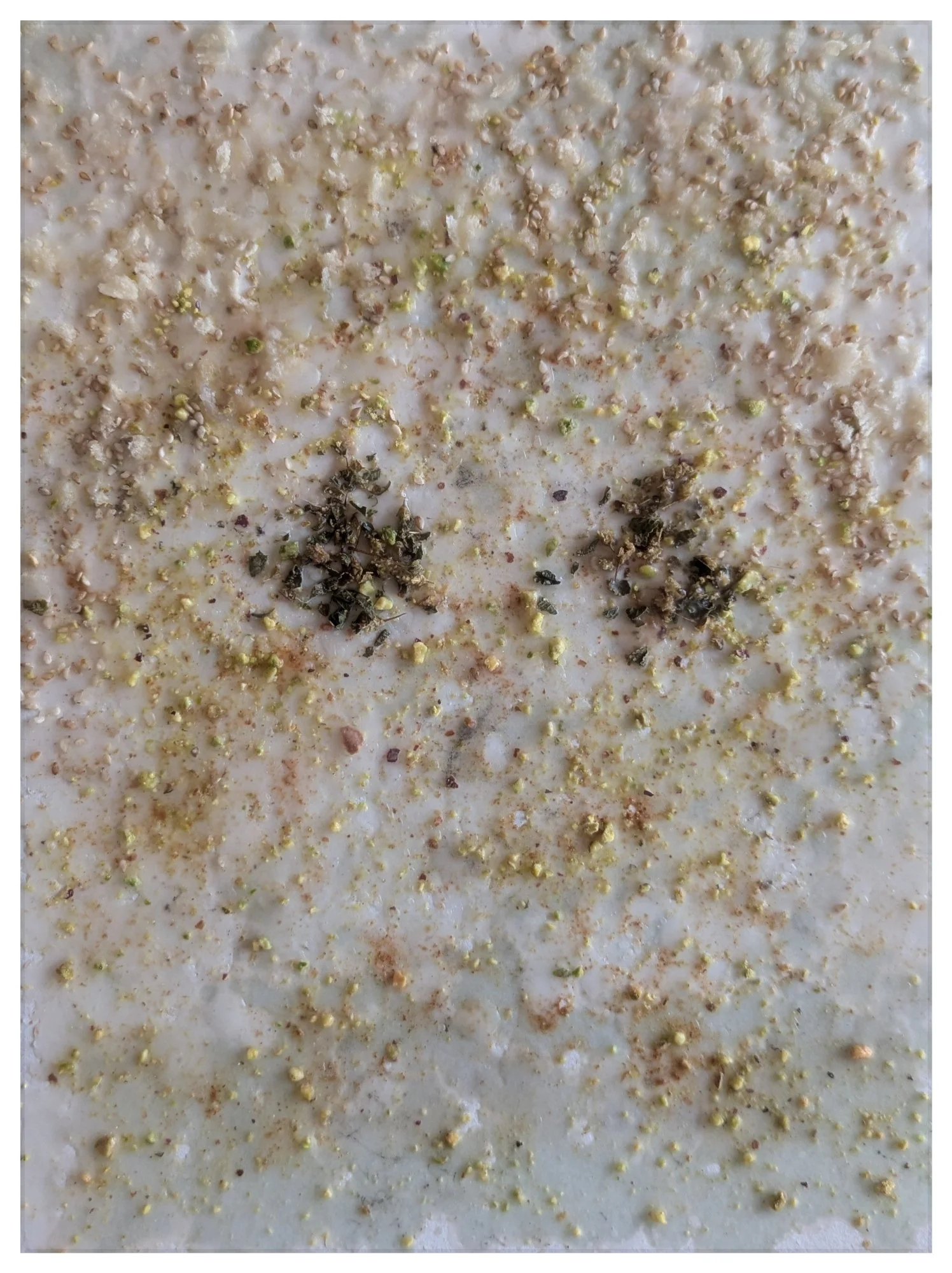 Edwards_My Baby (Mono No Aware)_sesame seeds, canela, panko, rosemary, pistachios, wax on paper_2025_12 x 9 x 1 in. 30.48 x 22.86 x 2.54 cm.jpeg