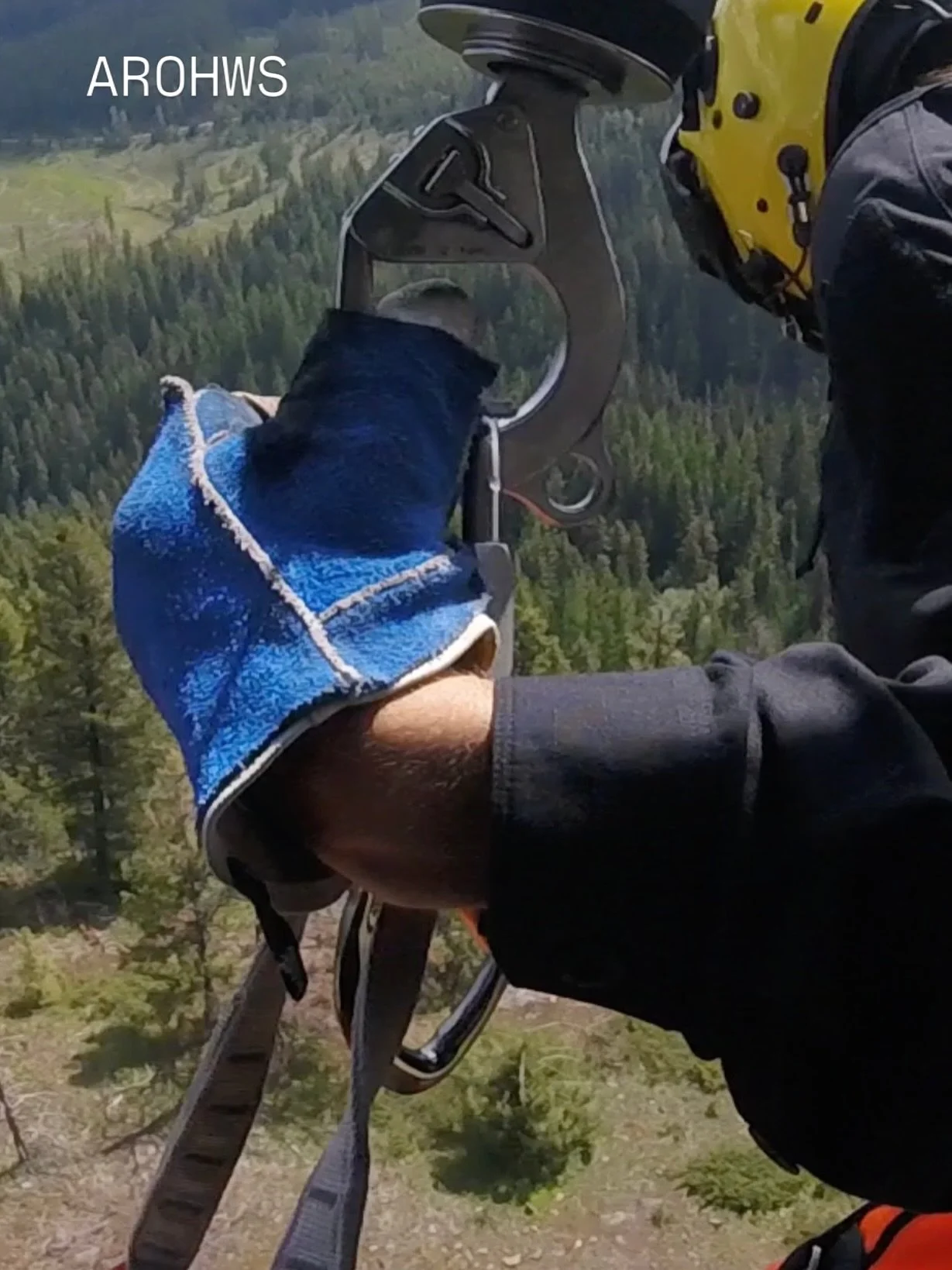 The winch operators wear an over glove, seen here in blue, to protect their hands from the cable. During winching, the cable runs through their hand to maintain control. The winch operators typically wear through several over gloves a season. 

#sear