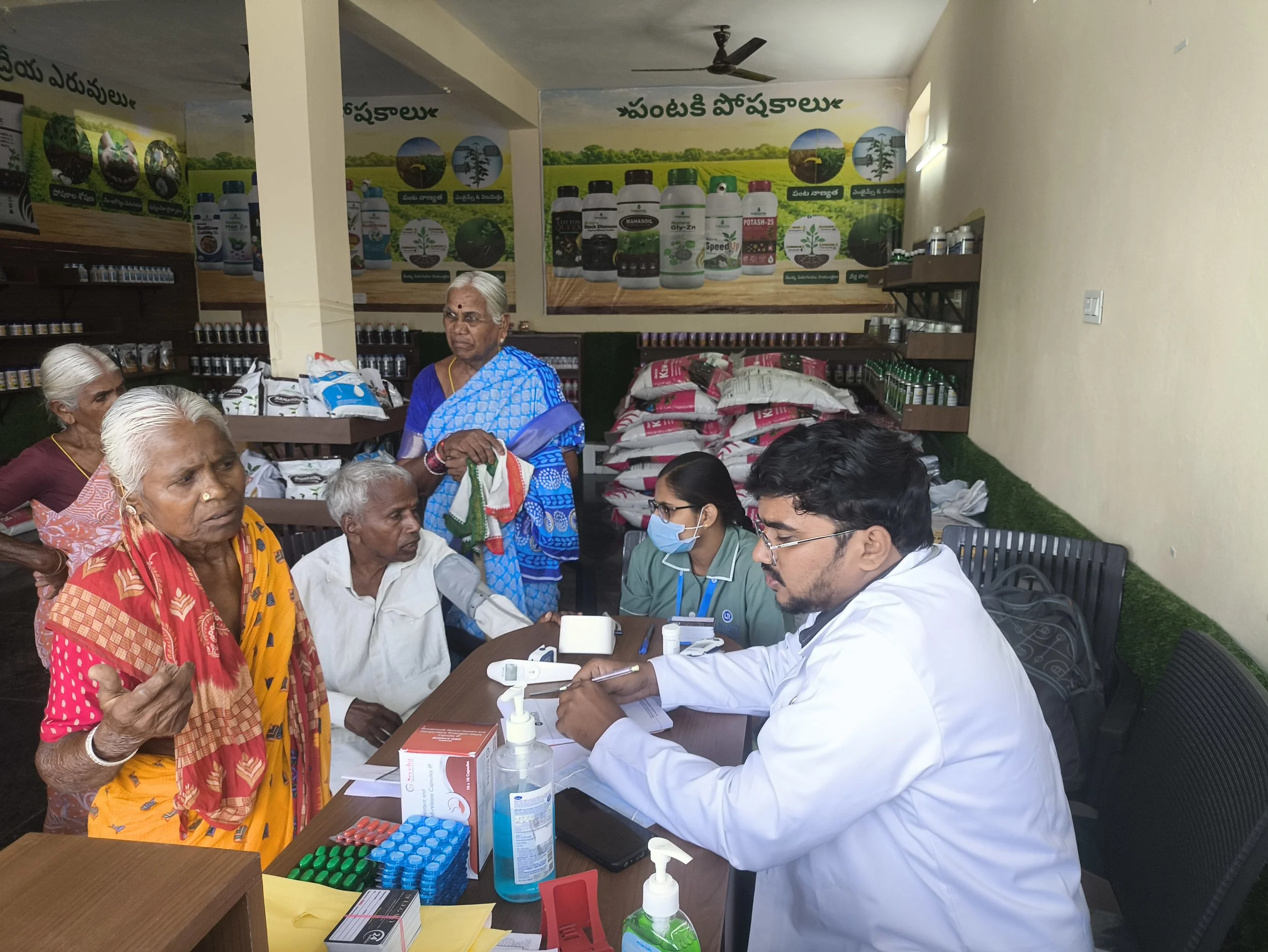 Elderly women receiving health screenings and medical consultations from healthcare workers at an Agrifields Foundation community health camp.