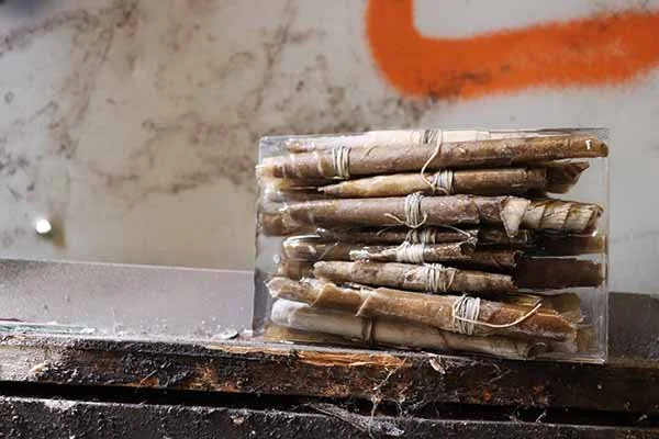 Wall Story No. 4, 2020, paper backing of plaster wall, string, resin 16 x 4.5 x 9.8 cm