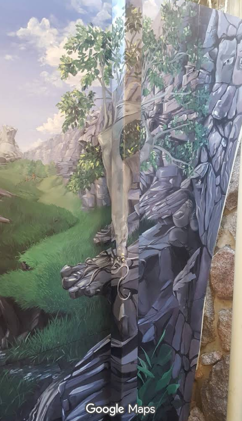 The pole is blended in with the mural