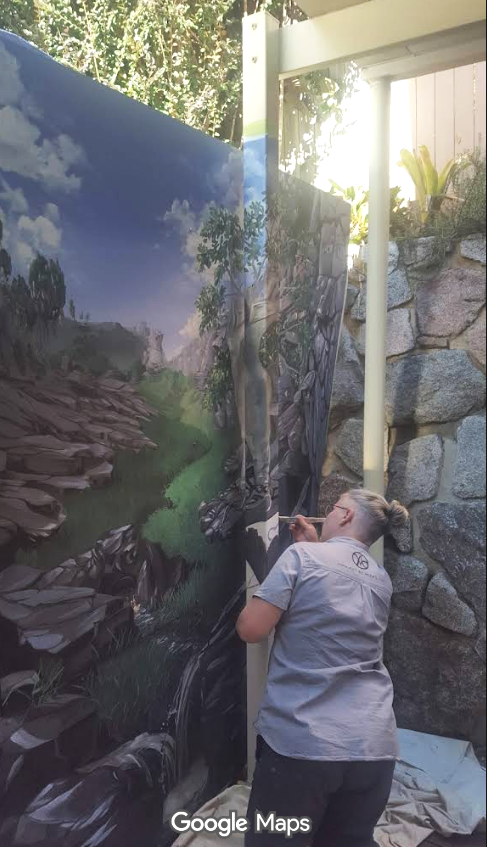 Mieke painting the pole to make it disappear