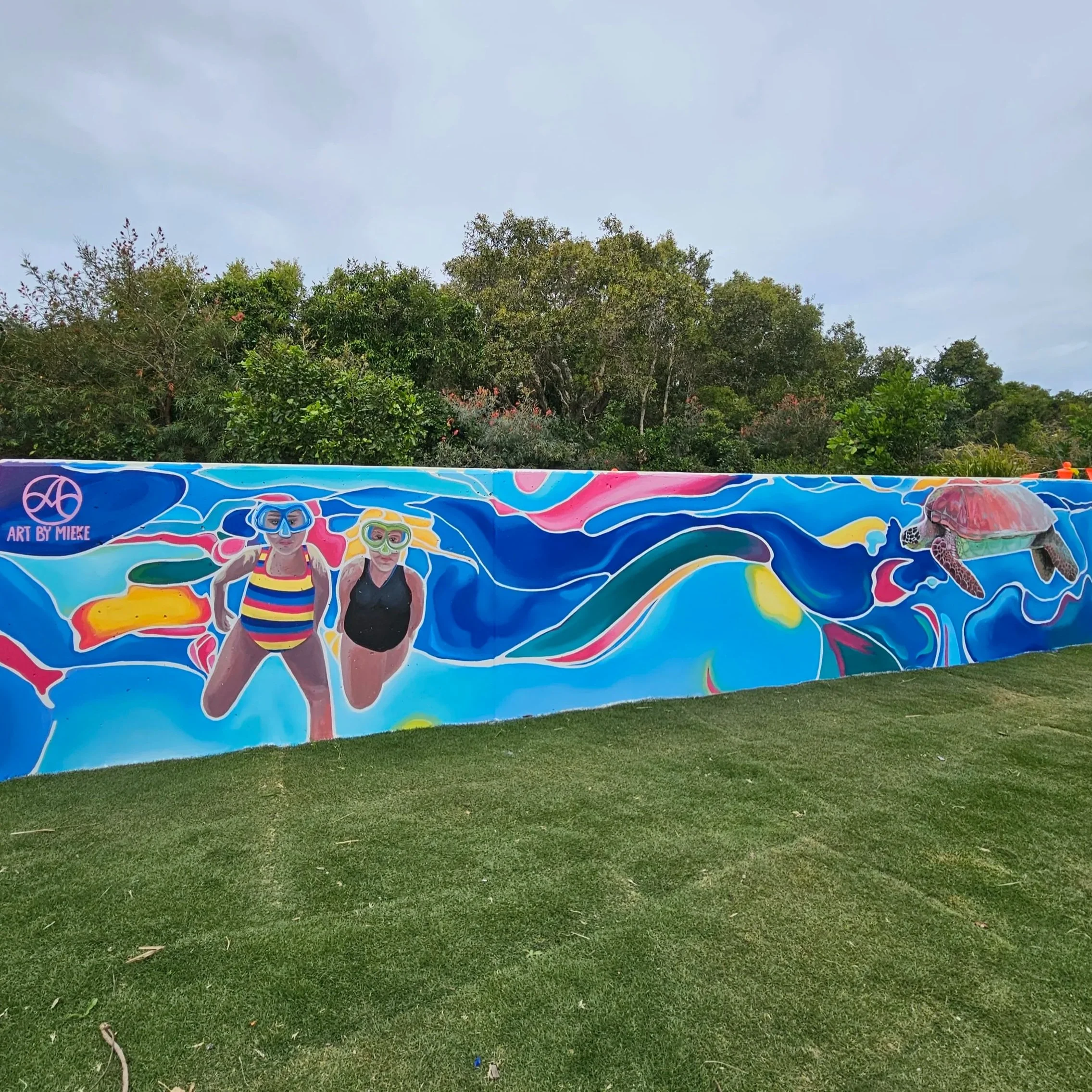 underwater with snorkelers turtle surfer mural at Bokarina across from the Bocca restaurant in Bokarina