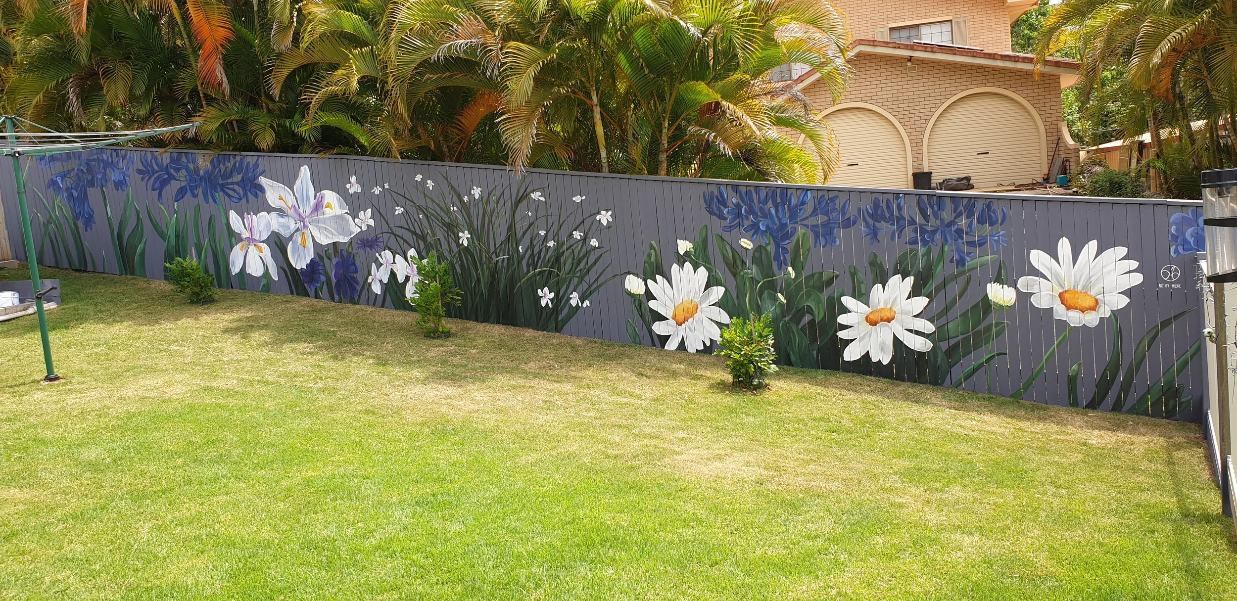 Flower mural on paling fence