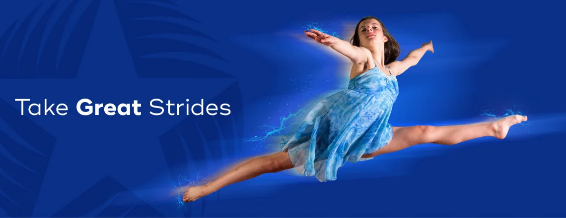A young girl in a blue dress performing a split leap in midair against a blue background with a large star in the background, accompanied by the text 'Take Great Strides'.