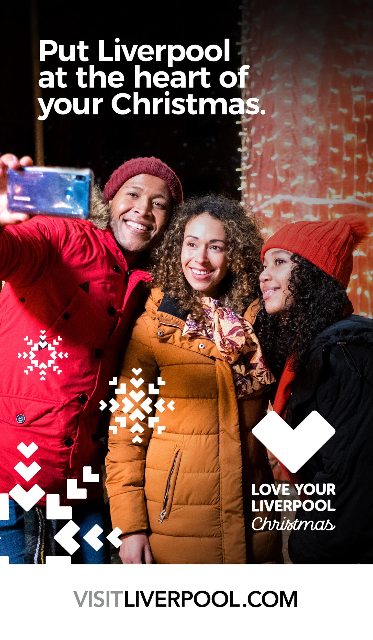 Three people taking a selfie at Christmas, wearing winter coats and hats, with festive lights in the background. Text on the image promotes Liverpool as a Christmas destination, with the message 'Put Liverpool at the heart of your Christmas' and 'Lov