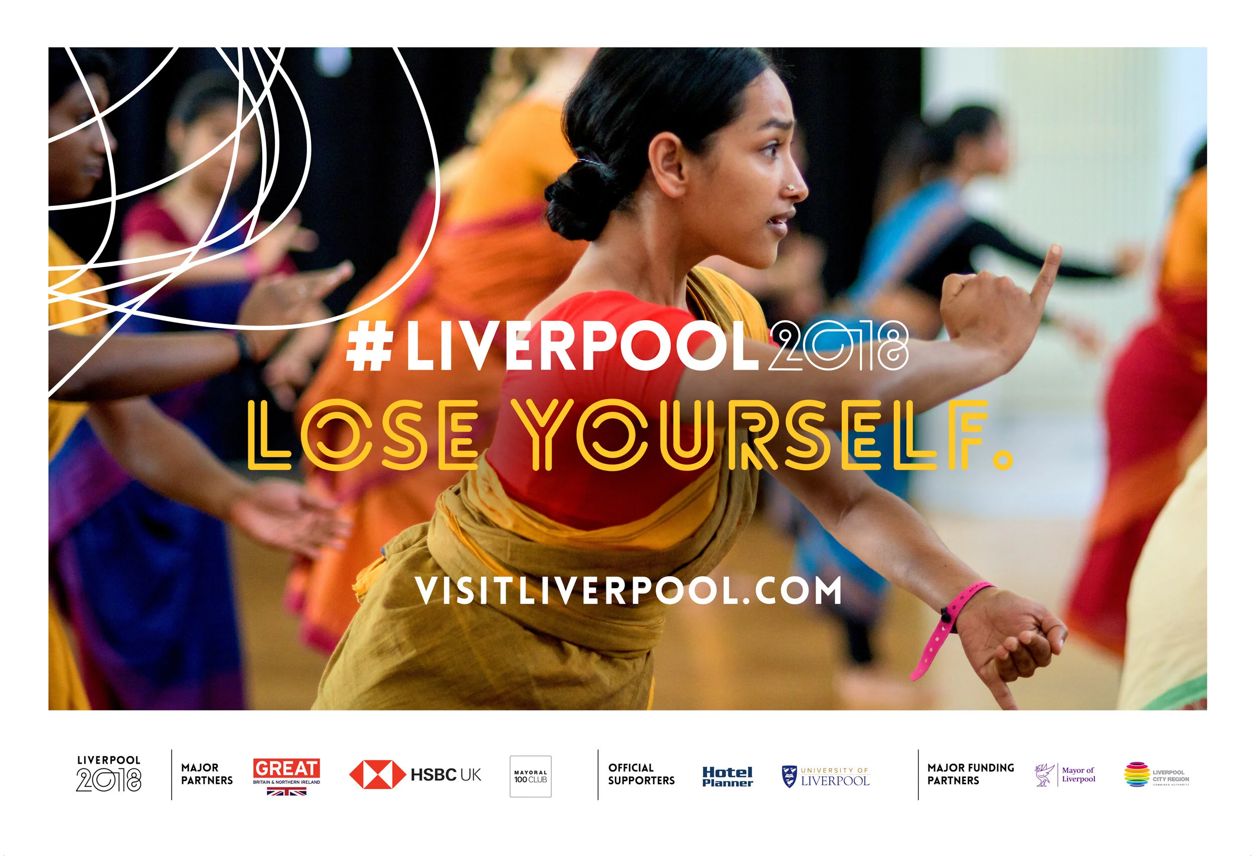 Group of women in traditional Indian attire participating in a dance or cultural event at Liverpool 2018 with the slogan 'Lose Yourself' and the website vistliverpool.com.