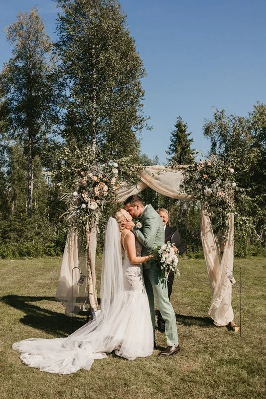 The couple’s first kiss at their garden wedding ceremony