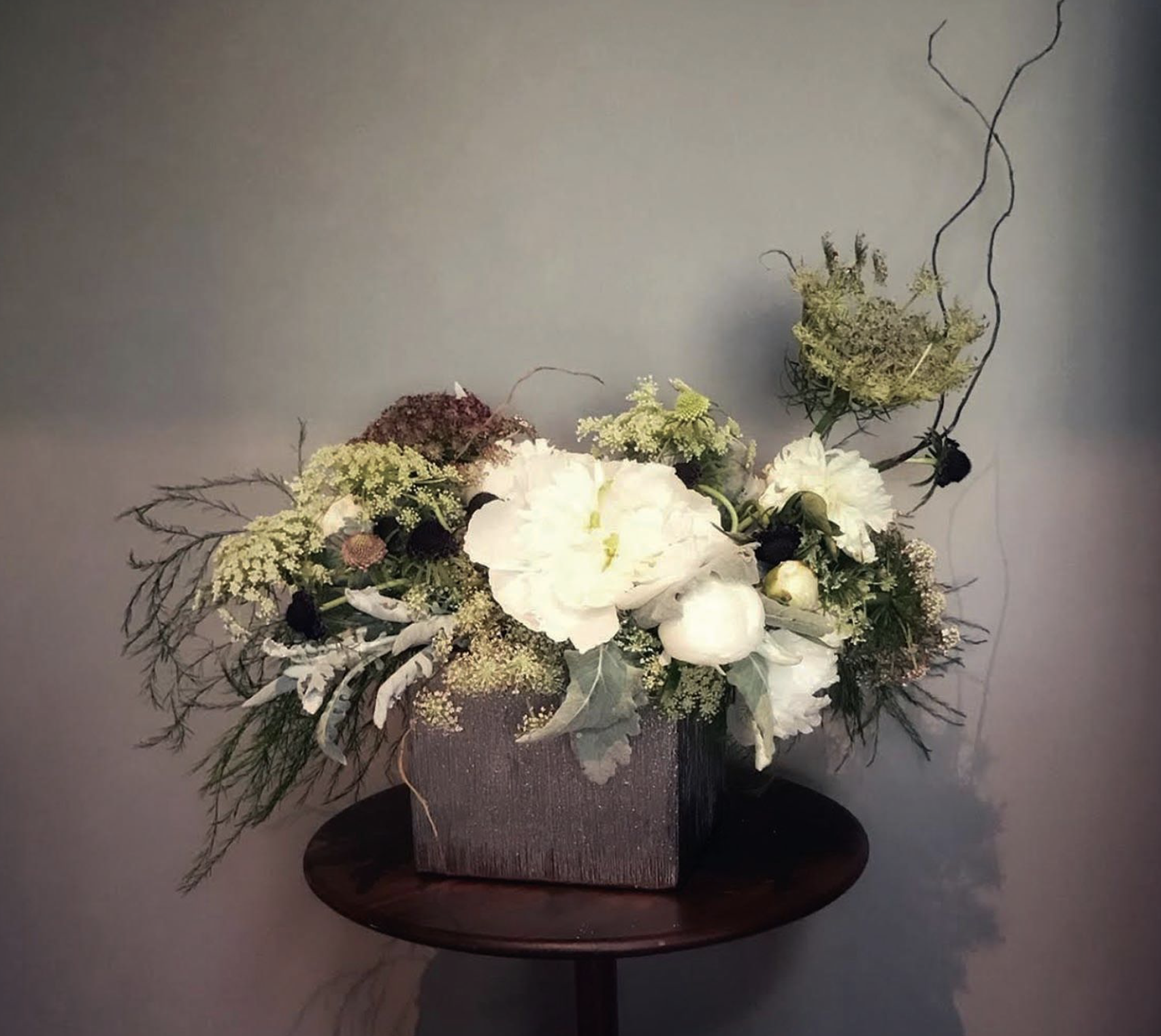 Tree Fern, Queen Anne’s Lace, Willow Branch, Gardenia, Lisianthus, Scabiosa, and Dusty Miller